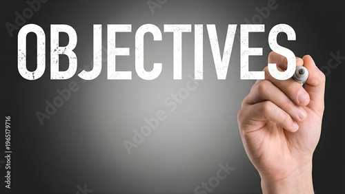 Hand writing objectives on blackboard background