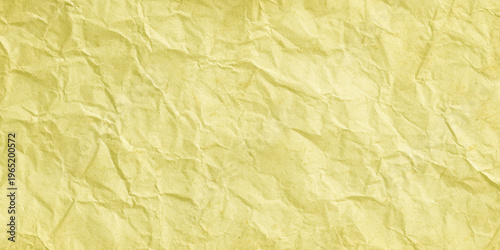Crumpled yellow paper texture background with creases and wrinkles for design and craft projects