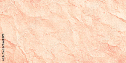 Soft pink crumpled paper texture background with creases and folds