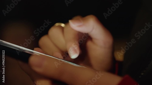 Closeup young hands rapid tapping screen with bright glow, quick swipes and multifinger presses, notifications flashing, urban night energy and concentrated focus, candid mobile use, roles include