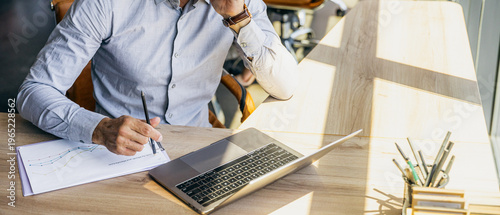 Bright office setting with meticulous bookkeeper analyzing reports
