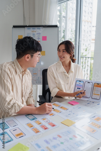 Ux ui designers collaborating on mobile app interface