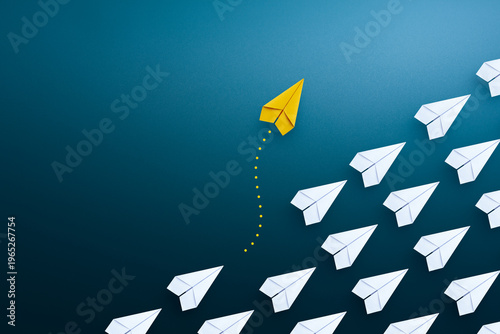 Group of paper plane in one direction and with one yellow paper plane individual pointing in the different way. Business concept for new ideas creativity and innovative solution.
