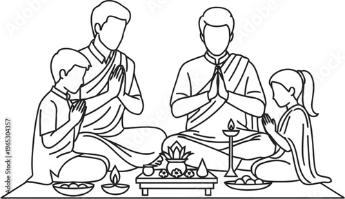 A family of four praying together during a traditional indian festival celebration at their home