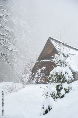 Traditional Wooden Tatra Mountain Hut Covered in Snow in Winter Landscape