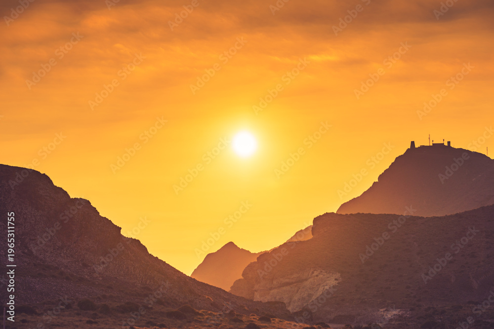Naklejka premium Sunset over coast mountain landscape