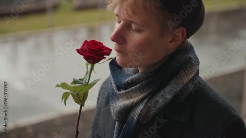 Peaceful time with gentle gesture. Peaceful moment characterized by tender smile and blooming blossom. An untroubled scene captured with delicate smile and flourishing flower in bloom