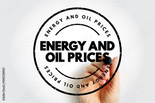 ENERGY AND OIL PRICES text on a circular stamp held by a hand. Economic and industrial concept for fuel costs and market trends