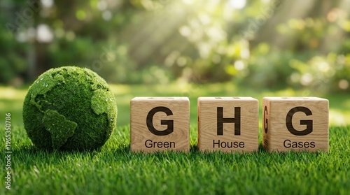 Green globe on grass with wooden blocks spelling ghg for greenhouse gases in a natural setting