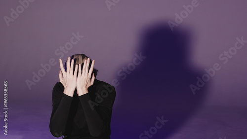 A close-up video of a young woman moving her hands away from her face to reveal a worried, searching gaze. Concept of psychological distress and human vulnerability.