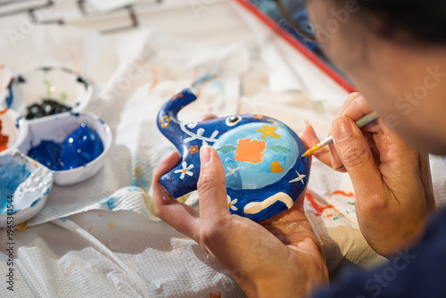 Close up of hands holding blue elephant craft