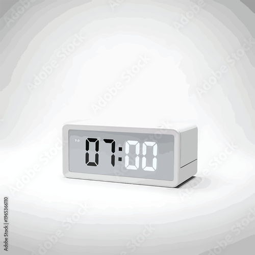 A digital clock displays the time as 0700 on a light gray screen. It sits on a white surface with a simple design. A gradient background