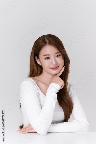 portrait beautiful young asian woman with brunette hair, healthy glowing facial skin and natural makeup on white background, for advertising cosmetics and beauty concept.