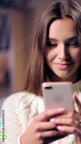 Woman smiles while engaging with smartphone during casual chat indoors. Animated chat badges.