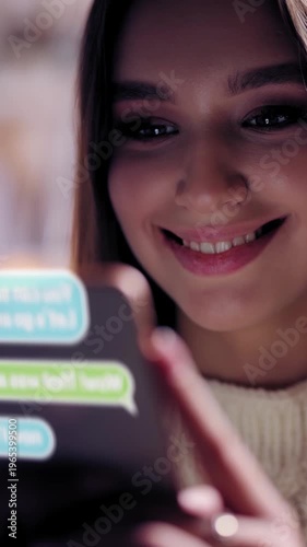 Woman smiles while texting on smartphone in a bright, cozy space at night. Animated chat badges.