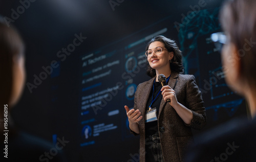 Confident Businesswoman Giving Inspiring Presentation at Technol