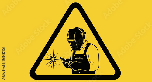 A person wearing protective gear is welding in an industrial setting.