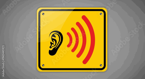 A sign with an ear and sound waves is posted indoors.