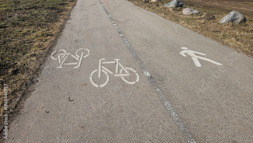Pedestrian and bicycle lane markings on shared asphalt path in Riga Latvia