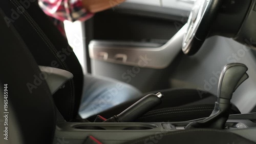 A man opens the car door and gets in to go to work in a world facing an oil shortage. A global energy crisis.