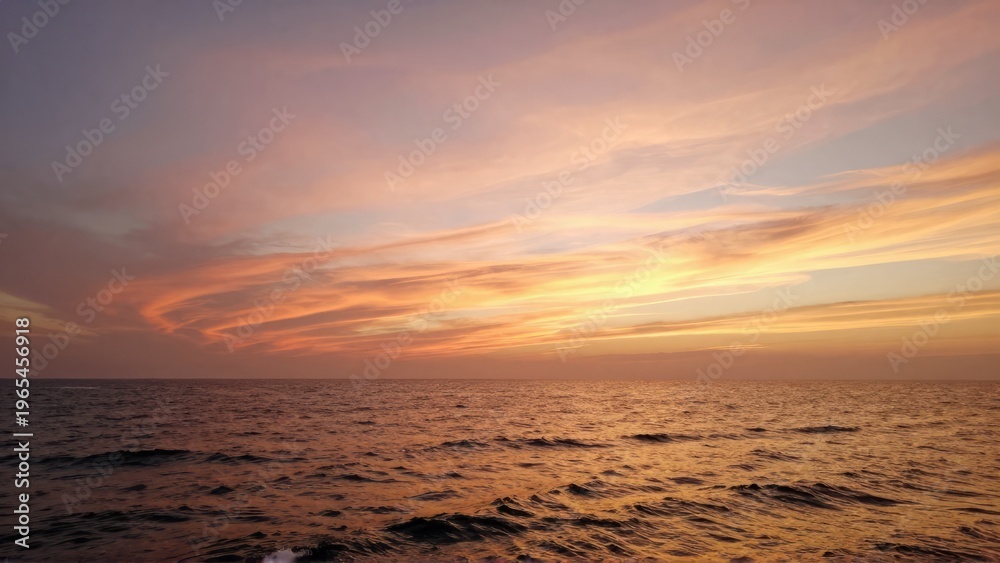Fototapeta premium Golden Sunset Seascape with Gentle Waves and Cirrus Clouds Wide Screen