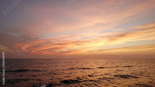 Golden Sunset Seascape with Gentle Waves and Cirrus Clouds Wide Screen