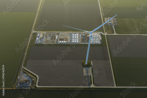 Aerial view of wind turbine powering energy storage units in netherlands
