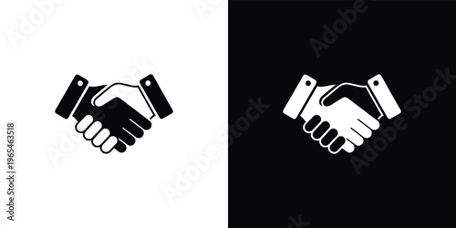Black and white handshake on split background business agreement partnership