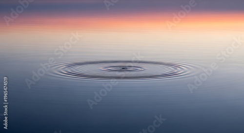Mesmerizing circular ripple in the placid water surface, subtly reflecting the gentle hues of a dawn or dusk sky, evoking a sense of calm and natural simplicity