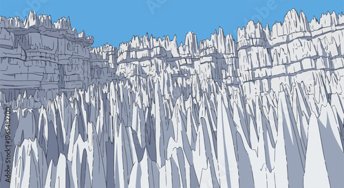 Jagged grey rock formations rise sharply against a clear blue sky