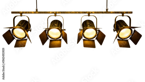 Isolated vintage film set spotlights with warm glowing lamps on a distressed metal bar