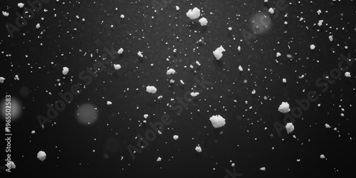 Heavy snowfall with large clumps of snowflakes falling on dark surface