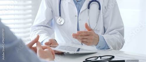 Photos Female doctor explaining diagnosis to her patient during a medical consultation in a bright medical office, healthcare and medical concept