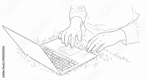 Person using a laptop computer outdoors on a grassy area