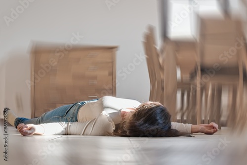 Quadro su tela Woman lying on the floor at home, epilepsy, unconsciousness, faint, stroke, accident or other health problem