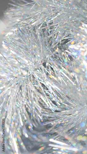 Shimmering silver tinsel strands with iridescent reflections for holiday decoration backdrop