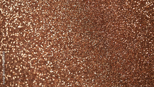 Shimmering bronze glitter texture background with sparkling particles for design projects