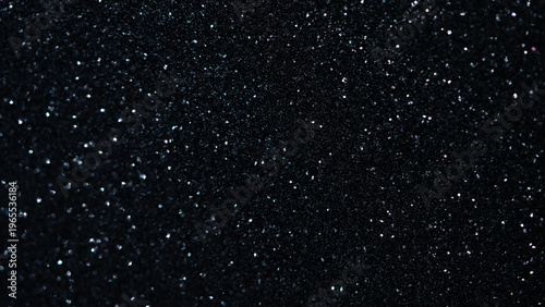Black glitter texture with shimmering particles creating a sparkling background effect