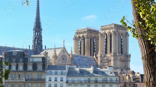 The iconic twin towers of Notre-Dame cathedral seen from the right bank of the Seine river in Paris, France