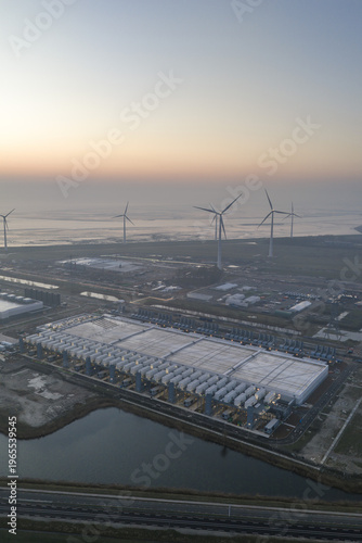 Aerial view of hyperscale data center with wind turbines in eemshaven