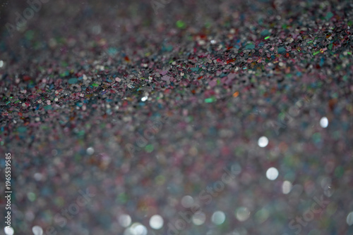 Close-up of colorful glitter particles creating a shimmering background texture for design projects