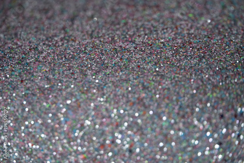 Close-up of shimmering glitter surface with colorful reflections and sparkling texture