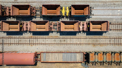 Aerial view of rail wagons resting on parallel tracks, their weathered surfaces hinting at journeys past, Vila Nova de Gaia, Portugal.