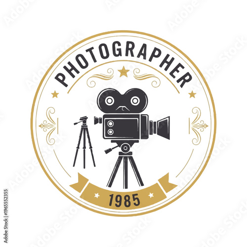 Vintage photographer emblem featuring a classic film camera on a tripod with an ornate circular seal and 1985 banner.