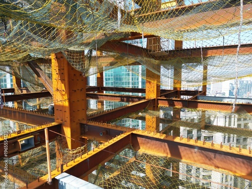 Фотография Detailed interior of a steel skyscraper structure with safety nets