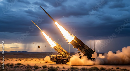 A military missile launcher fires two missiles into the stormy desert sky