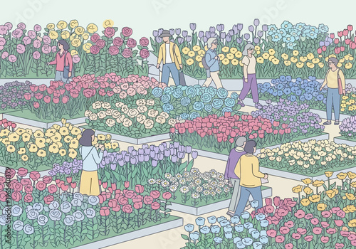 People admiring a vibrant display of flowers in a garden.