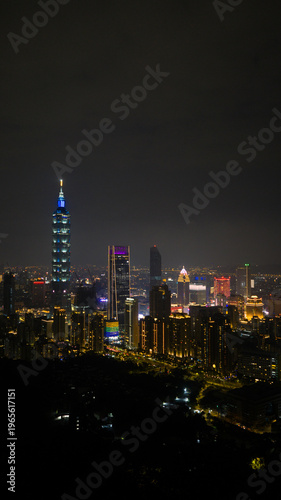 Wallpaper Mural Aerial view of Taipei 101 skyscraper illuminated at night among city lights and modern architecture in Xicun Village, Taipei City, Taiwan. Torontodigital.ca