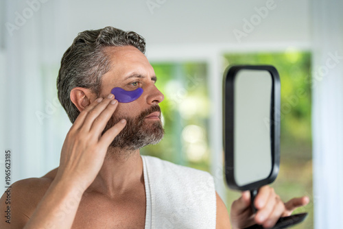 Eye patch. Beauty man face with under eye collagen pads. Skin with moisturizing patches under eyes. Beauty skin cosmetology of man with patch. Man use eye patch. Vitamin collagen patches. Cosmetology