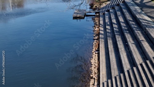 wooden steps used for sitting by water, urban terrace or residential staircase structure is made of wooden boards Function Serves as public space for relaxation, water observation or access to river o